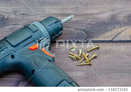 Set of fasteners and power tool demonstrate preparation for installation Set of fasteners and power tool demonstrate preparation for installation 138573283