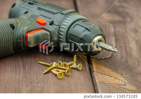 Metal screws and tool showing process of work and installation 138573285