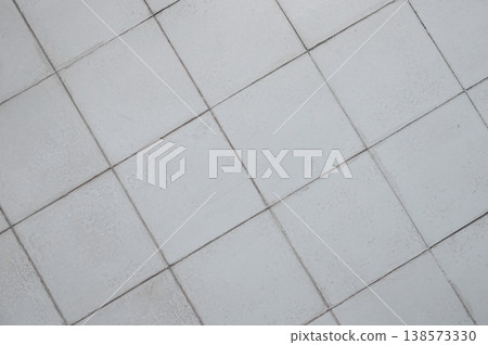Gray ceramic tile background in a minimalist style. Interior design concept. Gray ceramic tile background in a minimalist style. Interior design concept. 138573330