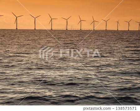 Wind turbines power generator farm along coast sea Wind turbines power generator farm along coast sea 138573571