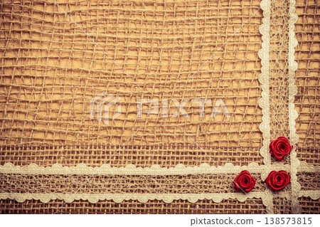 Frame of red silk roses on cloth Frame of red silk roses on cloth 138573815
