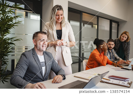 Group of People Sitting Around a Table With a Laptop Group of People Sitting Around a Table With a Laptop 138574154