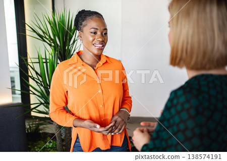 Women Talking in Orange Shirt 138574191