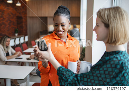 Woman Holding Cell Phone and Coffee Woman Holding Cell Phone and Coffee 138574197