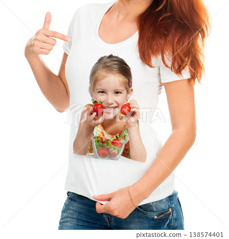 Plain white cotton t-shirt with a print of a lovely smiling child with strawberries Plain white cotton t-shirt with a print of a lovely smiling child with strawberries 138574401