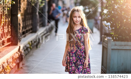 Beautiful little girl on a city street, evening fashion shot 138574423