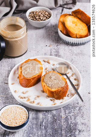Toast with sesame and sunflower tahini on a plate on the table vertical view Toast with sesame and sunflower tahini on a plate on the table vertical view 138574626