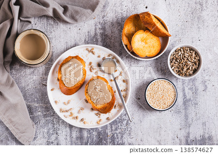 Urbech made from sesame and sunflower seeds on bread on a plate top view Urbech made from sesame and sunflower seeds on bread on a plate top view 138574627