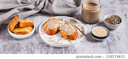 Urbech made from sesame and sunflower seeds on bread on a plate web banner Urbech made from sesame and sunflower seeds on bread on a plate web banner 138574631