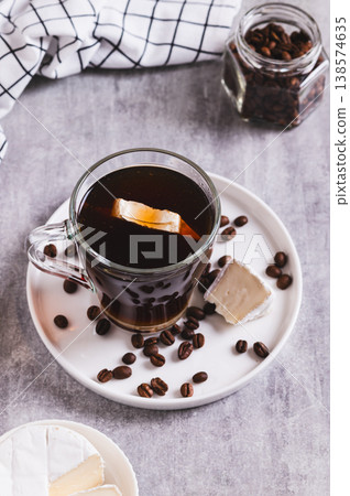 Espresso brie coffee in a cup and cheese in a bowl on the table vertical view Espresso brie coffee in a cup and cheese in a bowl on the table vertical view 138574635