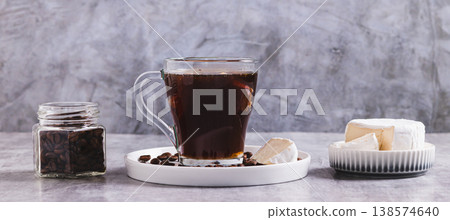 Black coffee with a piece of brie cheese in a glass on the table web banner Black coffee with a piece of brie cheese in a glass on the table web banner 138574640