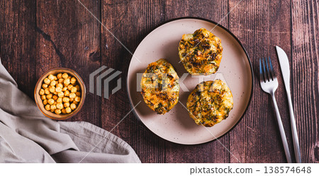 Baked potatoes with cheese and dill on a plate on the table top view web banner Baked potatoes with cheese and dill on a plate on the table top view web banner 138574648