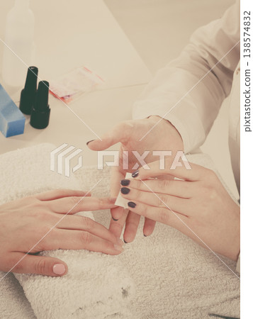 Woman making manicure using nail polish remover Woman making manicure using nail polish remover 138574832