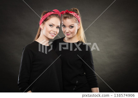 Loving sisters in retro pin up stylization. 138574906