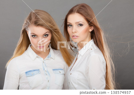 Two beautiful women, blonde and brunette posing Two beautiful women, blonde and brunette posing 138574937