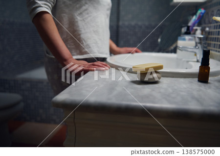 Middle Aged Woman in Pyjamas Doing Morning Face Care at Bathroom Sink Middle Aged Woman in Pyjamas Doing Morning Face Care at Bathroom Sink 138575000
