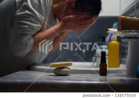 Middle-Aged Woman Washing Face During Morning Skincare Routine In Bathroom Middle-Aged Woman Washing Face During Morning Skincare Routine In Bathroom 138575010