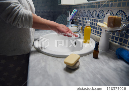 Middle-Aged Woman Washing Hands During Morning Skincare Routine In Bathroom Middle-Aged Woman Washing Hands During Morning Skincare Routine In Bathroom 138575026