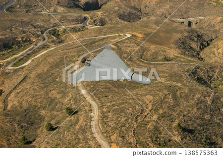 Military drone performs reconnaissance and attack over transport infrastructure of region Military drone performs reconnaissance and attack over transport infrastructure of region 138575363