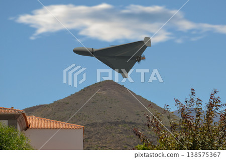 Military drone over residential area in Middle East region Military drone over residential area in Middle East region 138575367