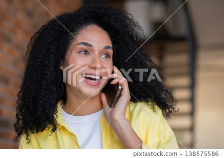 Pretty young long-haired woman in yellow jacket working from home Pretty young long-haired woman in yellow jacket working from home 138575586