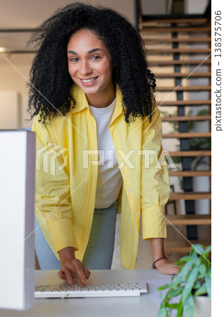 Young long-haired self-employed woman working from home and looking busy 138575706