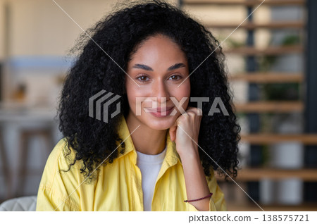 Pretty young brunette woman looking thoughtful Pretty young brunette woman looking thoughtful 138575721