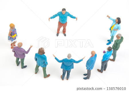 Miniature people gather in a circle for discussion in a creative setting with colorful figurines Miniature people gather in a circle for discussion in a creative setting with colorful figurines 138576010