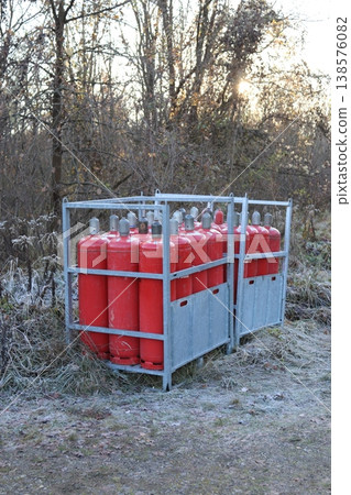 Red gas cylinders in a steel container on the street Red gas cylinders in a steel container on the street 138576082