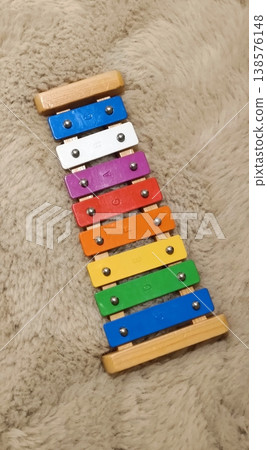 Children's metallophone on a soft brown carpet. Children's metallophone on a soft brown carpet. 138576148