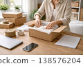 Small business owner packing cardboard box for online order delivery 138576204