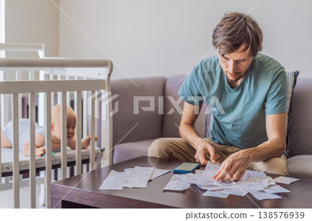 Father sitting on sofa calculating monthly expenses with receipts while baby lies in crib nearby at home. Stressed dad managing budget and childcare. Financial pressure and parenthood concept Father sitting on sofa calculating monthly expenses with receipts while baby lies in crib nearby at home. Stressed dad managing budget and childcare. Financial pressure and parenthood concept 138576939