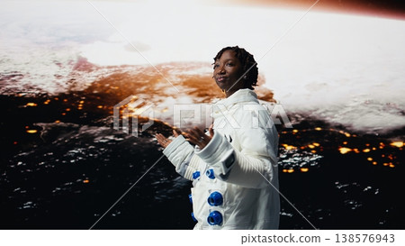 Happy cosmonaut seeking extraterrestrial life on Mars opens arms wide, excited to land. Jolly woman doing Martian surface research mesmerized by outer space, pleased by scientific discovery, camera A 138576943