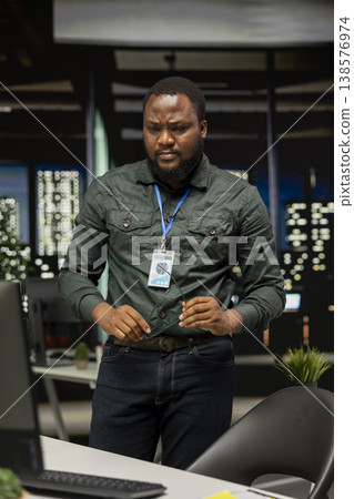 Black male consultant reflecting on a new company projection for growth, intuitive strategy and critical thinking with multiple solutions. Employee working after hours concentrating. Black male consultant reflecting on a new company projection for growth, intuitive strategy and critical thinking with multiple solutions. Employee working after hours concentrating. 138576974