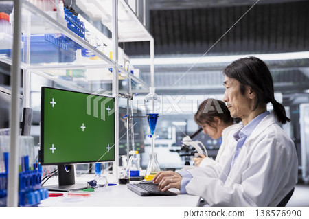 Chroma key computer application used by senior laboratory technician for DNA data analysis. Asian research facility worker using bioinformatics genomics software on green screen PC Chroma key computer application used by senior laboratory technician for DNA data analysis. Asian research facility worker using bioinformatics genomics software on green screen PC 138576990