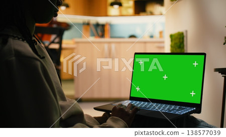 Chroma key on laptop with black female relaxing in hallway at home, focused on warm daylight and cozy ambience indoor. Calm interior shows modern lifestyle and peaceful everyday living. Chroma key on laptop with black female relaxing in hallway at home, focused on warm daylight and cozy ambience indoor. Calm interior shows modern lifestyle and peaceful everyday living. 138577039