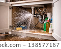 Pipe burst water leak under kitchen sink with spray and flooding 138577167