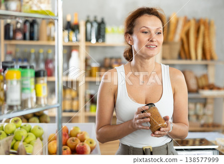 Adult woman choosing lentils in grocery store Adult woman choosing lentils in grocery store 138577999