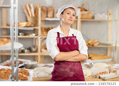 Woman baker standing with folded arms 138578125