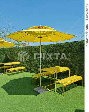 It is an outdoor cafe with parasols. 138578167