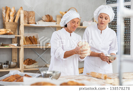 Interested female bakers discussing work processes in bakery Interested female bakers discussing work processes in bakery 138578278