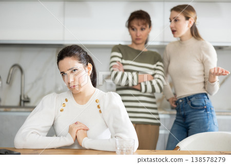 Two sisters during family quarrel accuse woman Two sisters during family quarrel accuse woman 138578279
