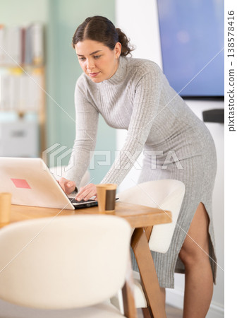 Working in modern office - businesswoman working on laptop Working in modern office - businesswoman working on laptop 138578416