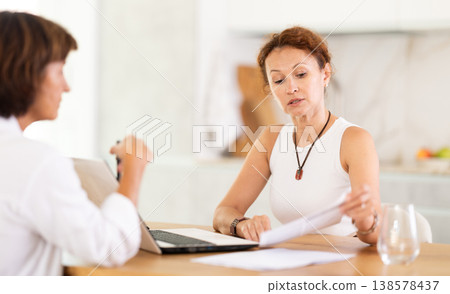 Female insurance agent tells woman the terms of property and life insurance Female insurance agent tells woman the terms of property and life insurance 138578437
