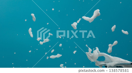White bubble foam fly in many shape form and splashing in air. Bubble foam use to clean wash toilet kitchen bathroom. Blue background isolated White bubble foam fly in many shape form and splashing in air. Bubble foam use to clean wash toilet kitchen bathroom. Blue background isolated 138578581