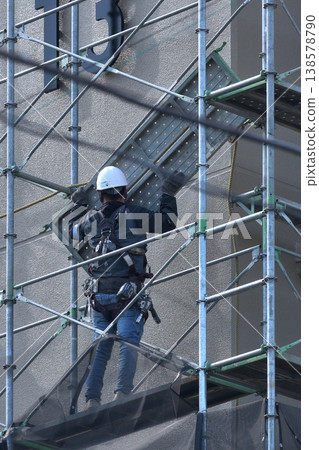 Dismantling site of temporary scaffolding during large-scale apartment building renovation. Dismantling site of temporary scaffolding during large-scale apartment building renovation. 138578790
