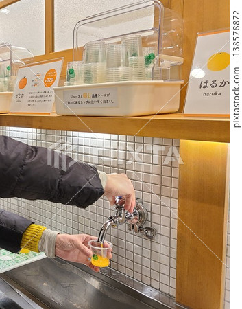 mandarin orange juice from the faucet mandarin orange juice from the faucet 138578872