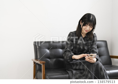 A woman using a mobile phone A woman using a mobile phone 138579513