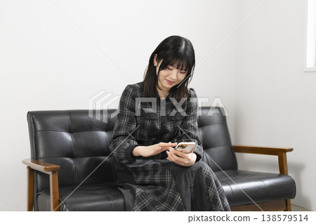 A woman using a mobile phone A woman using a mobile phone 138579514