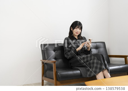A woman using a mobile phone A woman using a mobile phone 138579538